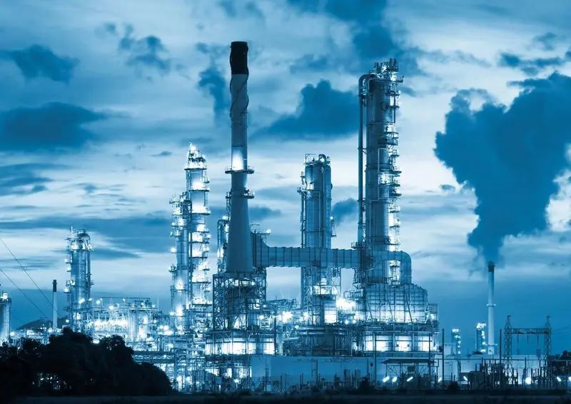 Refinery columns under a cloudy sky